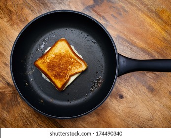 Photo of a grilled cheese sandwich cooking in a large frying pan. - Powered by Shutterstock