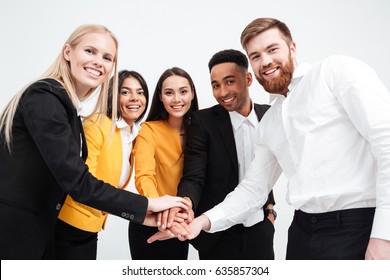 Photo Of A Group Of Cheerful Colleagues Business Team Standing In Office. Looking At Camera.