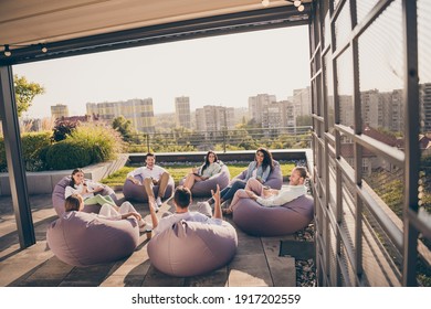 Photo Of Group Chief Leaders Sitting Bean Bags Discuss New Stratagy Workplace Workstation Outdoors Outside City Terrace