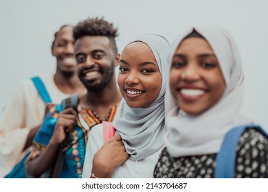 Photo of a group of happy african students talking and meeting together working on homework girls wearing traditional Sudanese Muslim hijab - Powered by Shutterstock