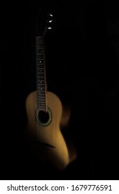 Photo Of A Guitar With A Single Light Source