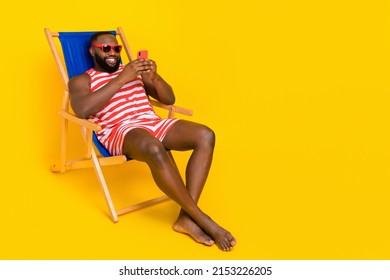 Photo Guy Student Sit Deckchair Use Device Relax Wear Barefoot Swim Suit Shorts Isolated Bright Color Background