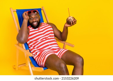 Photo Of Guy Tourist Sit Sun Bathing Chaise Longe Wear Red Striped Swim Shorts Isolated Bright Color Background