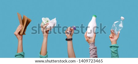 Photo of hands holding bottles, package for recycling