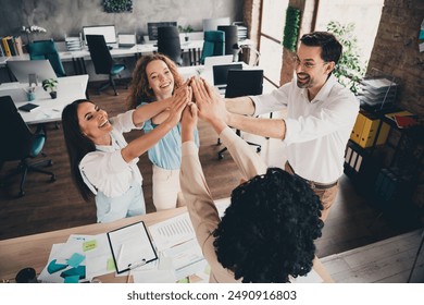 Photo of hands together high five teamwork young people working together employees modern industrial open space style interior workplace - Powered by Shutterstock