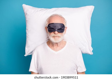 Photo of handsome aged person wear sleep mask cover eyes sleeping isolated on pastel blue color background