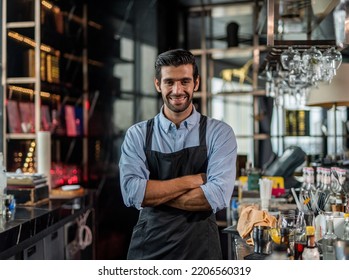 Photo of a handsome bartender behind the bar in a sky lounge bar in Bangkok - Powered by Shutterstock