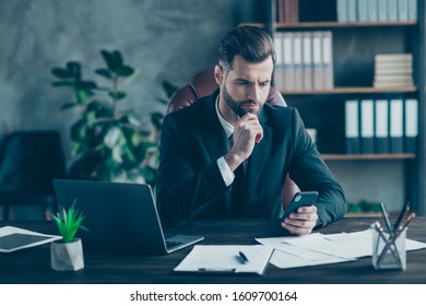 Photo of handsome business guy holding telephone hands waiting corporate colleagues partners call wear black blazer white shirt tie suit sitting big chair office indoors - Shutterstock ID 1609700164