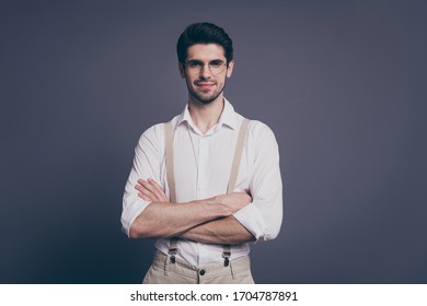 Photo Of Handsome Business Man Hands Crossed Charming Smiling Young Reliable Chief Dressed Formalwear White Shirt Beige Suspenders Specs Isolated Grey Color Background