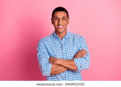 Photo of handsome confident guy wear plaid shirt arms crossed emtpy space isolated pink color background - Powered by Shutterstock