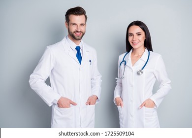 Photo Of Handsome Doc Guy Practitioner Experienced Professional Pretty Lady Two People Patients Consultation Virology Clinic Good Mood Wear Lab Coats Isolated Grey Color Background