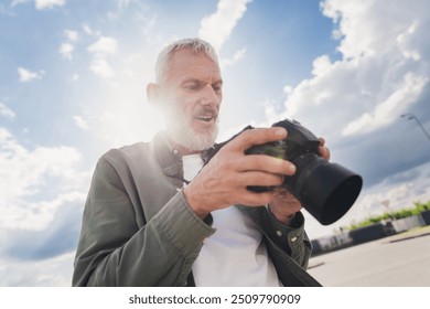 Photo of handsome good mood seniour guy wear green shirt taking camera pictures outdoors urban city street - Powered by Shutterstock