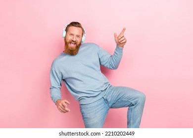 Photo Of Handsome Guy Ginger Beard Blue Sweater Dancing Listen Favorite Playlist On Streaming Platform Isolated On Pink Color Background