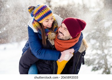 Photo of handsome guy hold on back adorable positive lady look each other have good mood free time outdoors - Shutterstock ID 2065892033