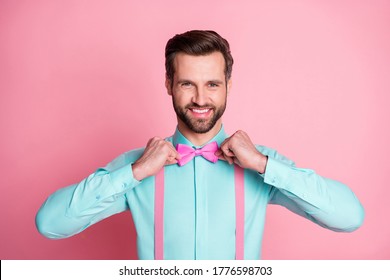 Photo of handsome macho guy trend clothes preparing corporate party retro theme well-dressed wear teal shirt suspenders bow tie isolated pastel pink color background