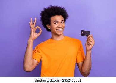 Photo of handsome positive guy hold debit card demonstrate okey symbol approval isolated on violet color background - Shutterstock ID 2352435551