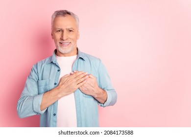 Photo Of Handsome Retired Man Arms On Heart Promise Honest Grateful Isolated Over Pink Color Background