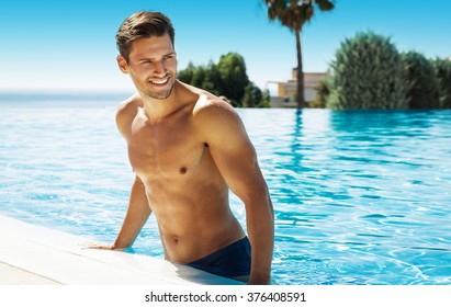 Photo Of Handsome Smiling Man In Swimming Pool In Summer Scenery