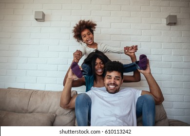 Photo Of Happy Black Family Having Fun At Home Sitting On The Sofa.