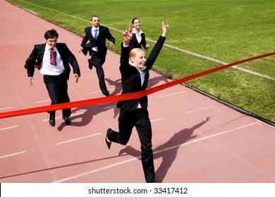 Photo Of Happy Businesswoman Crossing Finish Line During Race