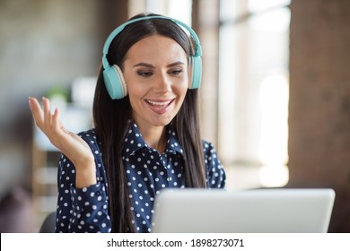 Photo of happy charming young business woman wear headset blue dotted shirt look computer meeting in office indoors