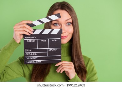 Photo Of Happy Cheerful Nice Young Woman Hold Hand Clapper Film Maker Isolated On Green Color Background