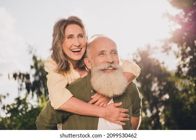 Photo of happy cheerful old man woman feel young piggyback ride weekend enjoy outside outdoors in park - Powered by Shutterstock