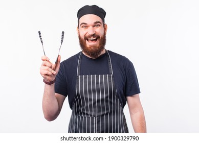 Photo Of Happy Chef Man Holding Utensil For Cooking Meat