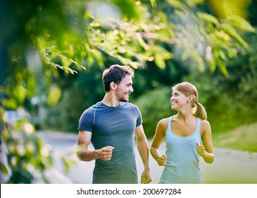 Photo Of Happy Couple Running Outdoors