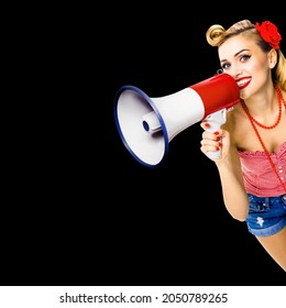 Photo Of Happy Excited Woman Holding Mega Phone And Saying Something. Blond Girl In Pin Up Style With Megaphone, Over Dark Black Background. Female Model In Retro Vintage Studio Sales Ad Concept. 