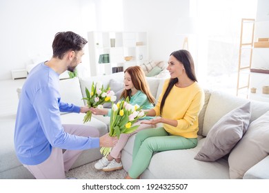 Photo Of Happy Family Positive Smile Celebrate Woman Day Dad Give Daughter Mom Flowers Bouquets Indoors