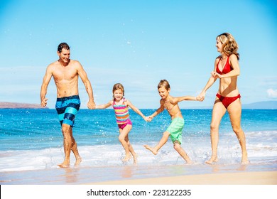 Photo Of Happy Family Running Down The Beach