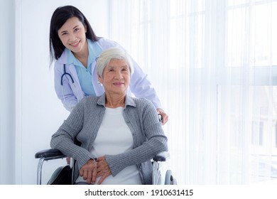 Photo Of Happy Female Doctor And Elderly Patients On Wheelchair. Elderly Patient Care And Health Care, Medical Concept.