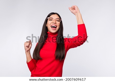 Photo of happy good mood charming excited crazy girl raise fists in victory triumph isolated on grey color background
