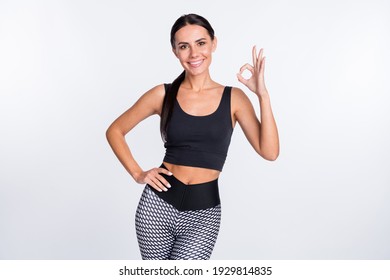 Photo of happy good mood smiling cheerful sportive athlete woman showing okay sign isolated on white color background
