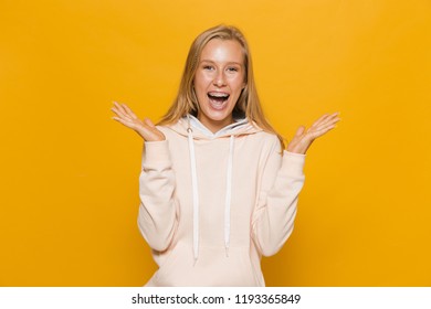 Photo Of Happy School Girl With Dental Braces Laughing At Camera Isolated Over Yellow Background