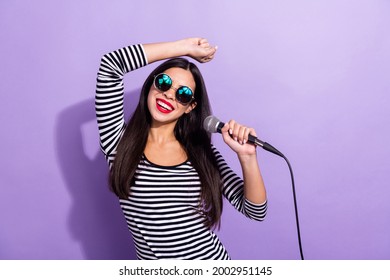 Photo of happy smiling positive charming korean girl in funky sunglass dancing singing isolated on violet color background - Powered by Shutterstock