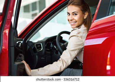 Photo Of Happy Young Mixed Race Woman Sitting Inside Her New Car. Concept For Car Rental