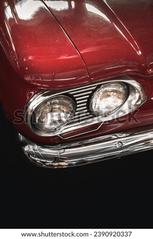 Photo of the headlights of a red car