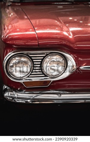 Photo of the headlights of a red car