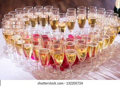 photo with heart of  glasses of champagne on festive table