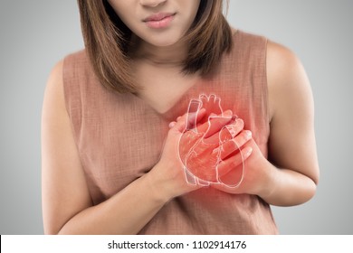 The photo of heart is on the woman's body, Severe heartache, Having heart attack or Painful cramps, Heart disease, Pressing on chest with painful expression. - Shutterstock ID 1102914176