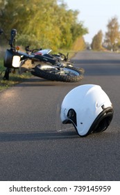 Photo Of Helmet And Motorcycle On Road, The Concept Of Road Accidents