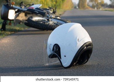 Photo Of Helmet And Motorcycle On Road, The Concept Of Road Accidents