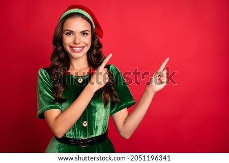 Photo of helper nice lady indicate finger promotion empty space wear elf costume hat isolated red color background