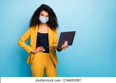 Photo of her she attractive chic classy lady using laptop wearing safety mask mers cov infection preventive measures working remotely from home wfh isolated blue color background - Powered by Shutterstock