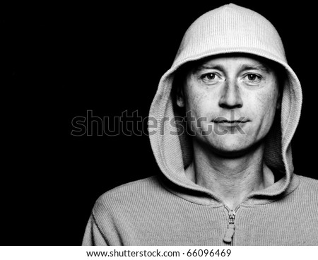 photo high contrast dark moody male in a hoodie funky clothes on black
