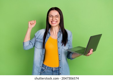 Photo Of Hooray Funny Brown Hairdo Lady Hold Laptop Wear Spectacles Jeans Shirt Orange Top Isolated On Green Color Background