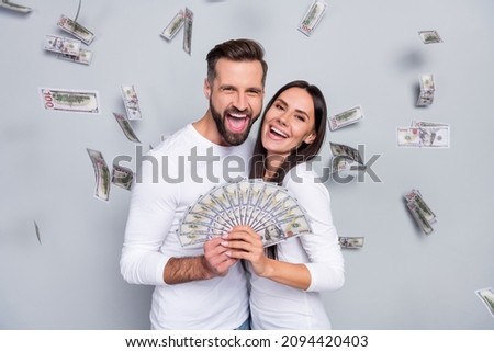 Photo of hooray young brunet couple win money wear white shirt isolated on grey background