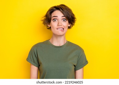 Photo Of Horrified Stressed Gorgeous Girl With Bob Hairstyle Wear Khaki T-shirt Biting Lips Staring Isolated On Yellow Color Background